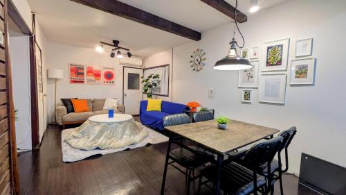 a living room with a table and a couch at Renovated Traditional Japanese House near Umeda , Entire Home for 8 in Osaka