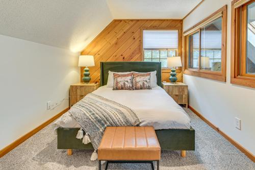 a bedroom with a bed and two windows at 8 Mi to Mt Snow Cozy Bear Cabin with Hot Tub! in Wilmington