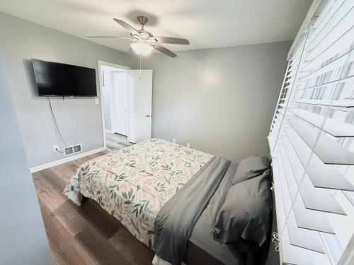a bedroom with a bed and a ceiling fan at Peaceful 4BR Haven in Stn Mtn GA in Stone Mountain