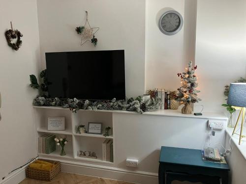 a living room with a flat screen tv on a wall at Seasalt Apartment in Barmouth