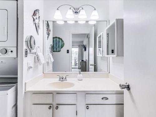 a white bathroom with a sink and a mirror at Adventure House RRYC17 in Rockport