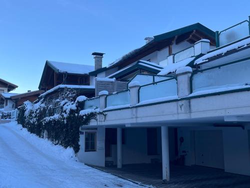 a building with snow on the side of it at Petra in Kirchberg in Tirol