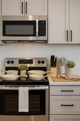 a kitchen with a stove and a microwave at Worker friendly A plus Location Warm and Cozy in Sherman