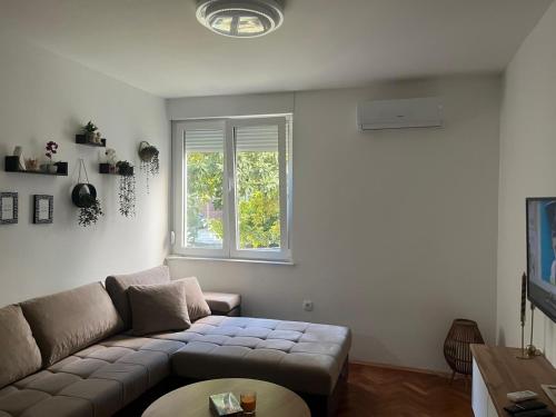 a living room with a couch and a window at Apartment Lara in Mostar