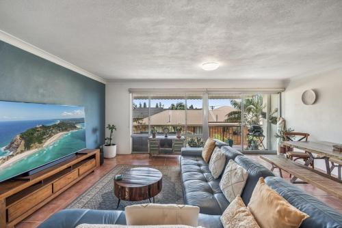 a living room with a large couch and a table at Wintersview 3 in Lennox Head