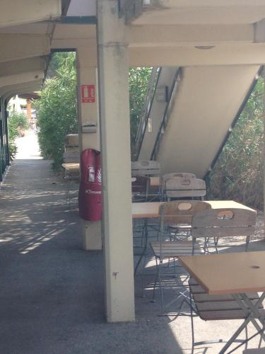 a group of tables and chairs in a building at Premiere Classe Salon De Provence in Salon-de-Provence