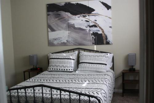 a bedroom with a bed with black and white pillows at Best Location in CS! Amazing Apartment in College Station