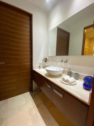 a bathroom with a sink and a large mirror at Arena Bca in Cruz de Huanacaxtle