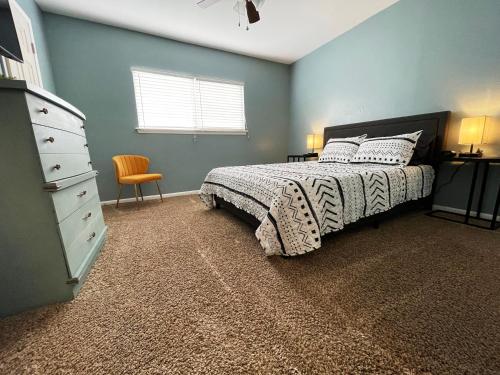 a bedroom with a bed with a dresser and a dresser at No Check-Out Work Sleeps 8! Family-Friendly C in College Station