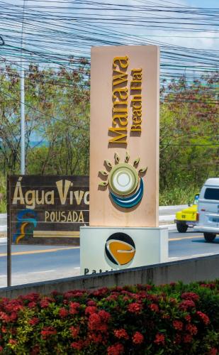 a sign for aza vinyasa restaurant on a road at Manawa Beach Flat A24 - Centro Porto de Galinhas in Porto De Galinhas