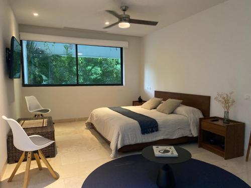 a bedroom with a bed and a large window at Arena Bca in Cruz de Huanacaxtle