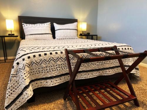 a bedroom with a large bed with a wooden frame at No Checkout Work! NEW Family Friendly Stay! in College Station