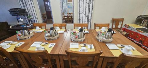 蓬塔阿雷纳斯La Casa Guesthouse的一张大木桌，配木椅和一张桌子