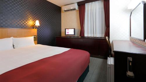 Ένα ή περισσότερα κρεβάτια σε δωμάτιο στο Pioland Hotel