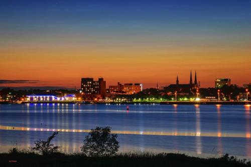 a view of a city at night with the water at Scenic Harbour View House Waterfront in Stratford