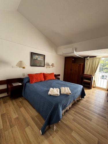 a bedroom with a bed with two towels on it at Hotel Aiello in San Luis