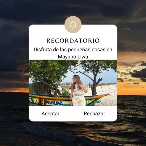 Una captura de pantalla de un teléfono celular con una mujer parada junto a un bote. en Mayapo Liwa 1, en Manaure