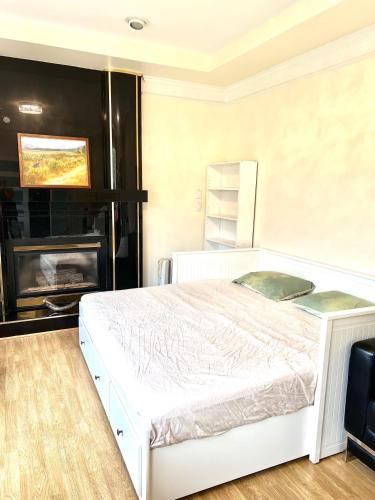 a bedroom with a white bed and a fireplace at Private 2BR, 1BA with shared Kitchen in a House, Free Parking, 15 Min YVR in Richmond
