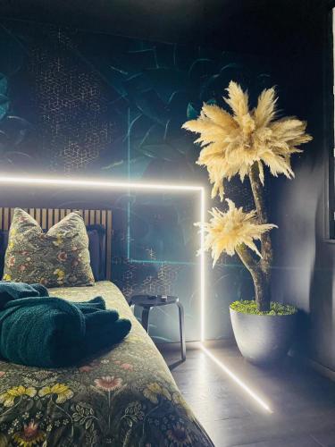 a bedroom with a bed and two large flowers at Cocon Romantique & Bain Nordique sur Vue Panoramique à Vichy in Vichy