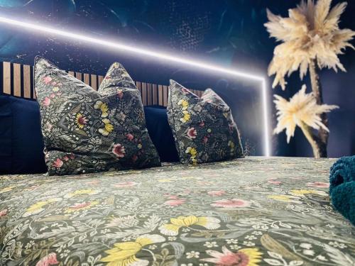 a bedroom with a bed with pillows on it at Evasion romantique à Vichy in Vichy