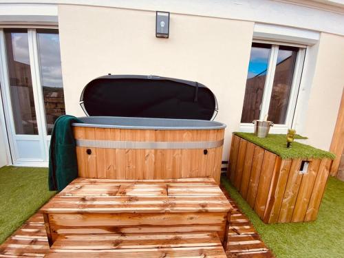a hot tub in the backyard of a house at Evasion romantique à Vichy in Vichy