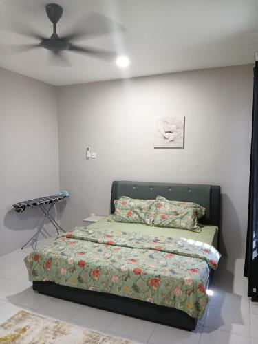 a bedroom with a bed and a ceiling fan at Fawa Homestay Jasin in Jasin