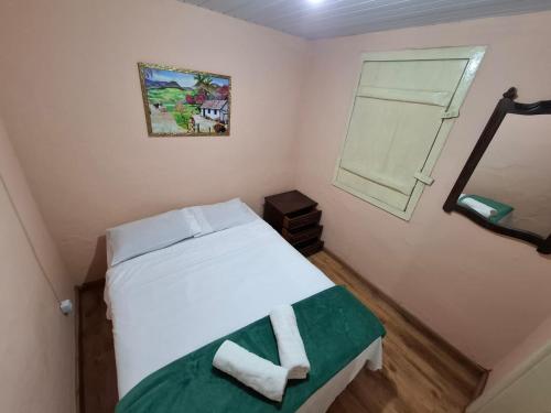 En eller flere senge i et værelse på Aluguel temporada