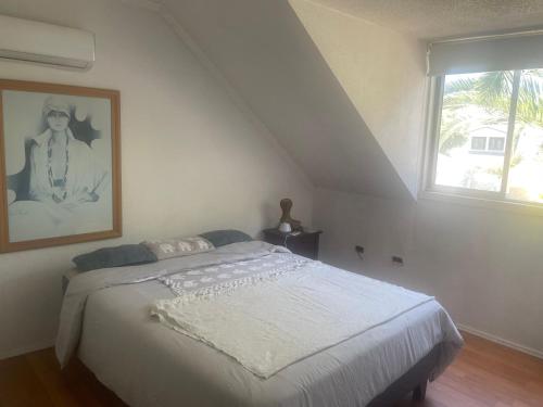 a bedroom with a bed with a picture on the wall at habitaciones exclusivas in Curicó