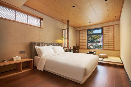 Ένα ή περισσότερα κρεβάτια σε δωμάτιο στο Nordsee Manor by Arcadia Collection - Laoshan, Qingdao