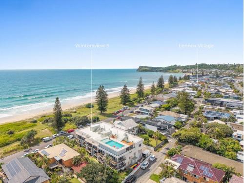 an aerial view of a beach with houses and the ocean at Wintersview 3 in Lennox Head