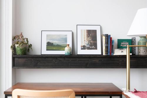 two frames sitting on a shelf with a table at Modern 1BR Apt with Rooftop, Gym, and Parking in Milwaukee
