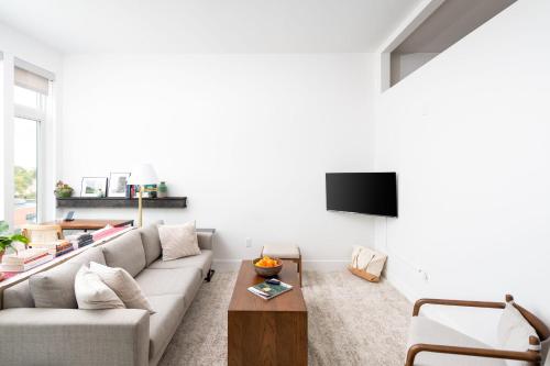 a living room with a couch and a table at Modern 1BR Apt with Rooftop, Gym, and Parking in Milwaukee