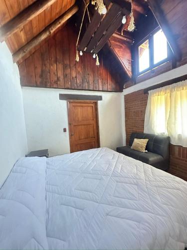 Ένα ή περισσότερα κρεβάτια σε δωμάτιο στο Cabaña Milagros