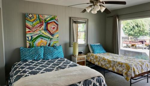 a bedroom with a bed and a couch and a window at Capitol Retreats-Views! Near Salt Palace,Sleep 28 in Garden Towers Condominium