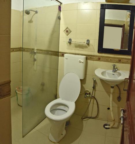 a bathroom with a toilet and a sink at Bay View Villa in Mahabalipuram
