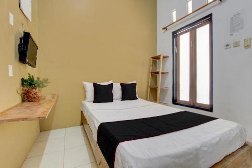 Postel nebo postele na pokoji v ubytování OYO 94881 Griya Barokah Syariah