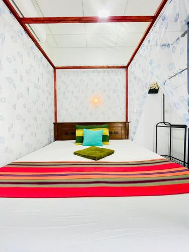 a bedroom with a large bed in a room at Double G Motel in Weligama