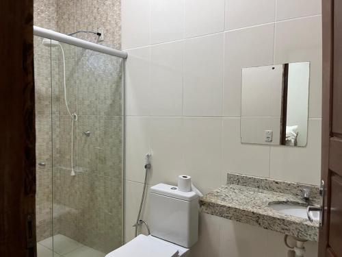 un bagno con doccia, WC e lavandino di Lar da Dora a Parauapebas