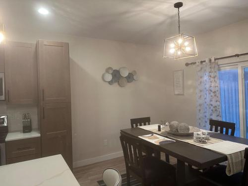a kitchen and dining room with a table and chairs at Luxurious Brand New Entire 3br and 2bath in Williston