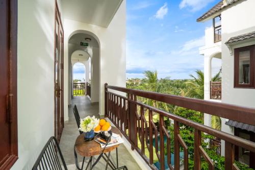 a balcony with a table with fruit on it at Ony Retreat Villas in Hoi An