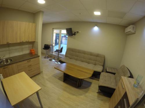a living room with a couch and a table at Kambarių nuoma Kačerginės kurorte in Kačerginė