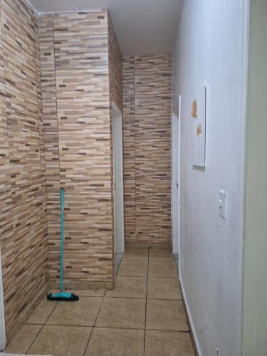 a hallway with a wooden wall with a mop at RR 2 Pousada e Restaurante in Manaus