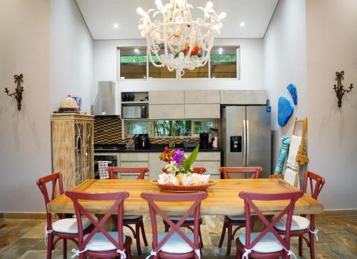 a dining room with a wooden table and chairs at Cabaña privada con piscina y jacuzzi junto al mar in Santa Veronica