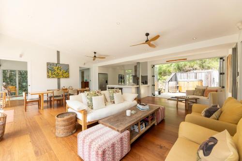 a living room with a couch and a table at Bimbimbie Lodge Killcare in Killcare