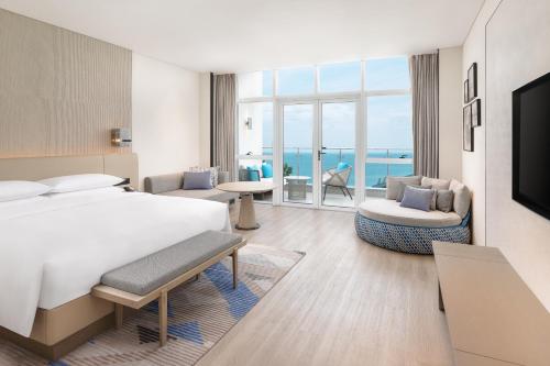 a hotel room with a bed and a view of the ocean at Sheraton Beihai Resort in Beihai