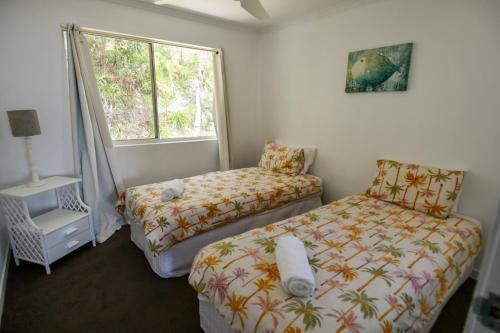 Ένα ή περισσότερα κρεβάτια σε δωμάτιο στο Moreton Island Villas and Apartments