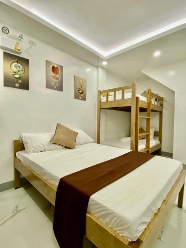 a bedroom with a bed and bunk beds at Casa Vina El Nido in El Nido