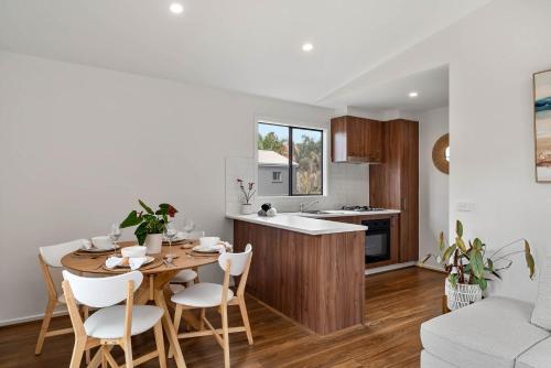 a kitchen and living room with a table and chairs at Beach Haven San Remo in San Remo