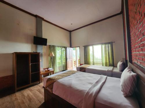 Ένα ή περισσότερα κρεβάτια σε δωμάτιο στο Istana Petani