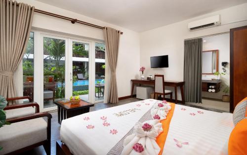 a bedroom with a bed with flowers on it at Indra Angkor Residence in Siem Reap